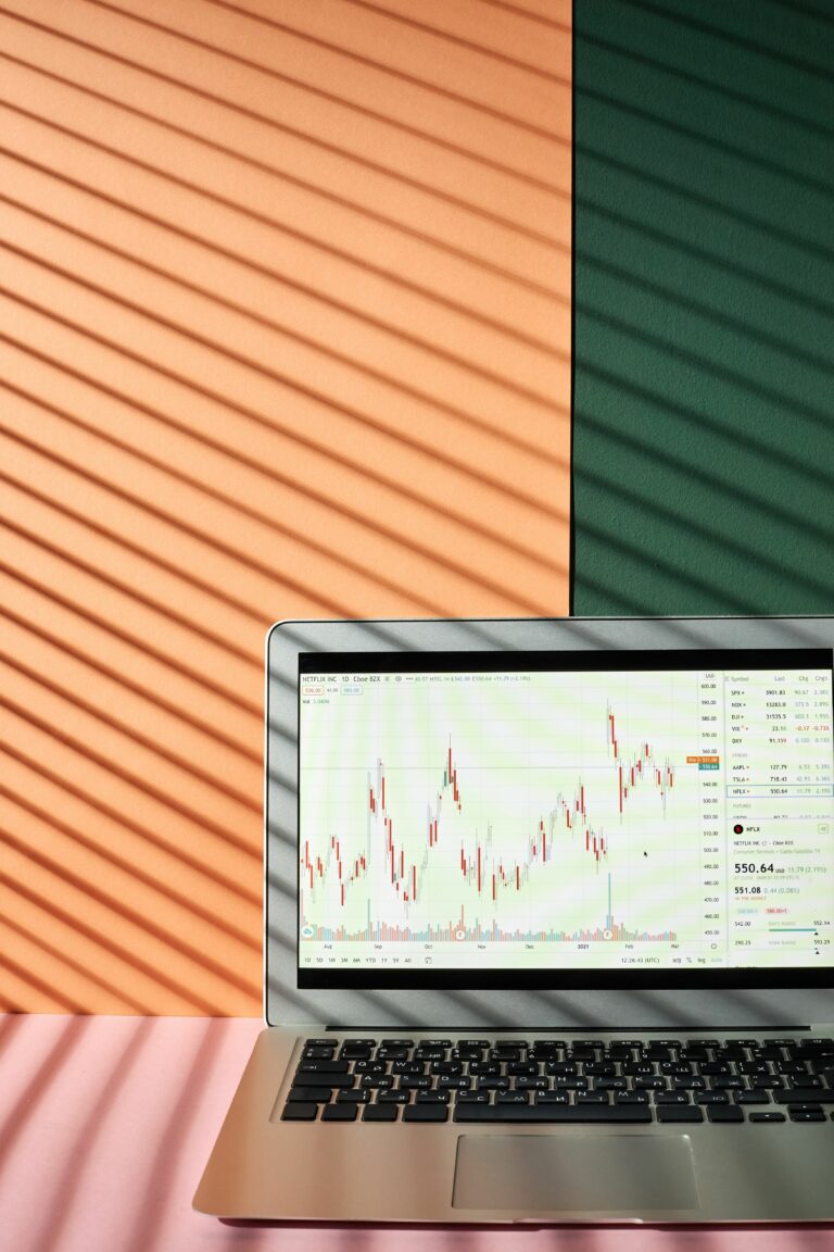 Laptop displaying financial graphs and investment charts for portfolio planning