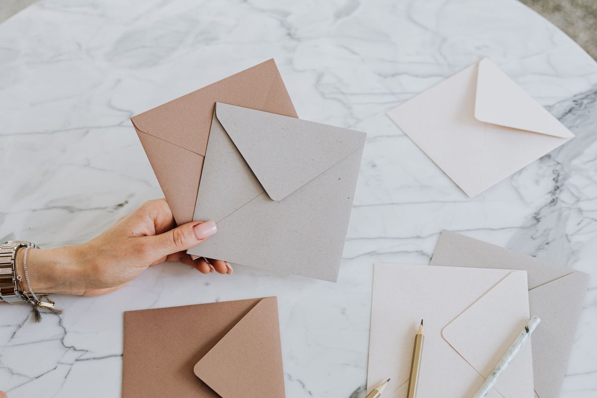 Woman holding envelopes representing the envelope budgeting method